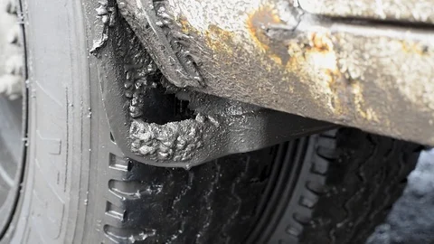 Old bus stands in the rain close-up of dirty wet wheel Stock Footage 107089157