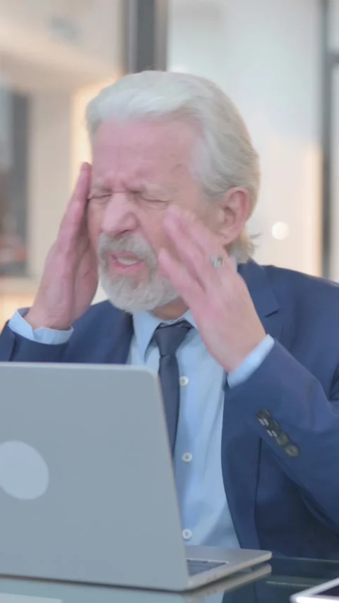 Old Businessman having Headache at Work, vertical video Video stock 325564712