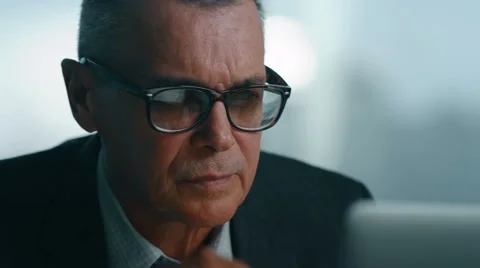 Old businessman leaned back in his office chair, he smile and daydreaming Stock Footage 60767247