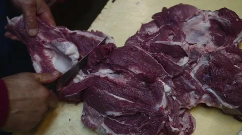 Old butcher cutting meat with knife in slow motion Stock Footage 44288831