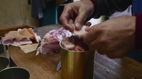 Old butcher filling cans with meat in slow motion Stock Footage 44297448