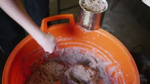 Old butcher putting meat paste into can in slow motion Stock Footage 44325015