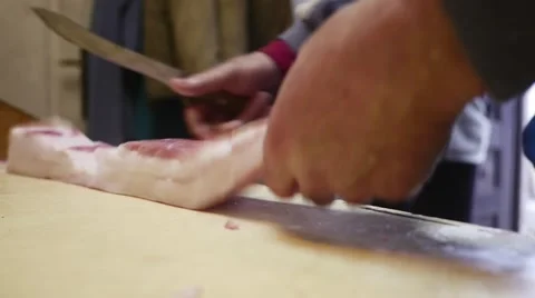 Old butcher separating fat from skin in slow motion Stock Footage 44291154