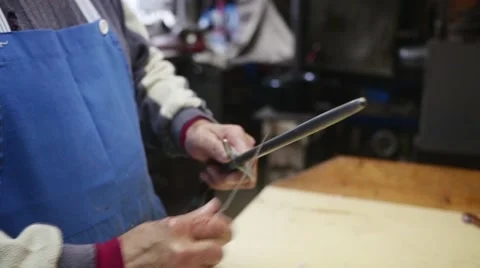 Old butcher sharpening his knife in slow motion Stock Footage 44292021