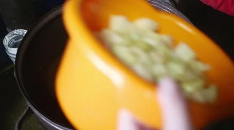 Old butcher throwing meat fat into pot in slow motion Stock Footage 44298169