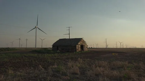 An old cabin surrounded by wind turbines in Texas, the old and the new, 4K. Stock Footage 244487034