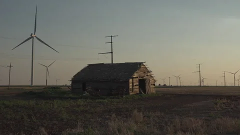 An old cabin surrounded by wind Turbines in the Panhandle of Texas, 4K. Stock Footage 244487499