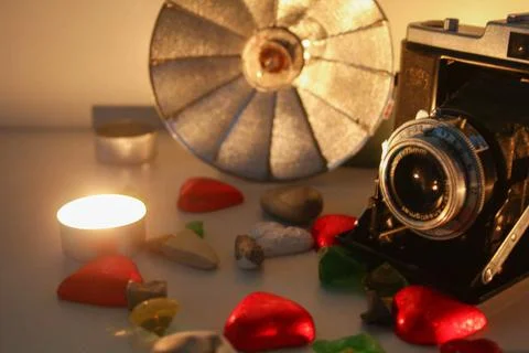 Old camera with flash and decor Stock Photos