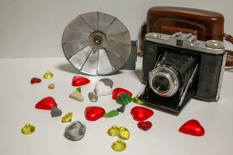 Old camera with flash and decorations Stock Photos