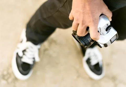 Old Camera hold by human hand for street photography. Stock Photos