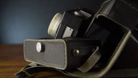 An old camera in a leather case. Slow motion and close-up Video stock 131965767
