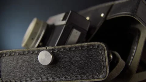 An old camera in a leather case. Slow motion and close-up Stock Footage 131965841