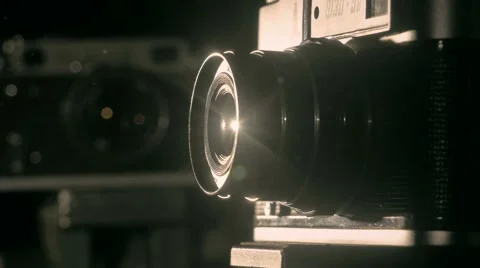 Old camera lens in the dark in the white lights studio indoors retro style Stock Footage 64853848
