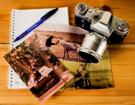 Old camera on the table with pictures Stock Photos