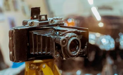 Old camera on a tripod Stock Photos