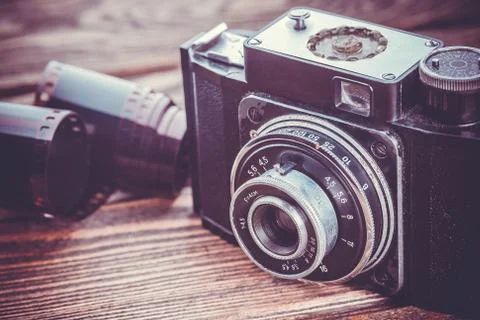 Old camera on wooden table Stock Photos