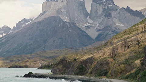 Old campervan on a road in front of mountains in Torres Del Paine, Patagonia Stock Footage 258419931