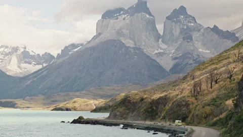 Old campervan on a road in front of mountains in Torres Del Paine, Chile Stock Footage 258423464