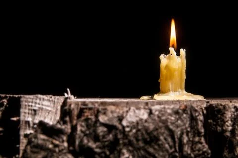 Old candle on the black background Stock Photos