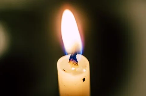 Old candle on the black background Stock Photos