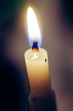 Old candle on the black background Stock Photos