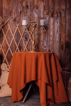 An old candlestick with candles on the table. Loft style in brown tones Stock Photos