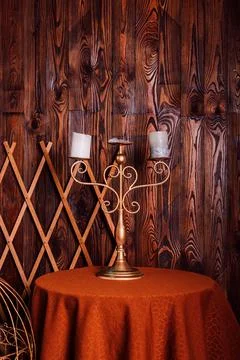 An old candlestick with candles on the table. Loft style in brown tones Stock Photos