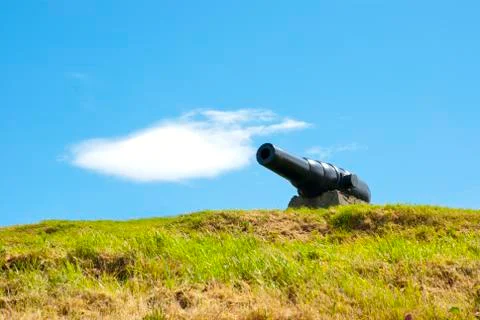 Old cannon on sky cloud Stock Photos