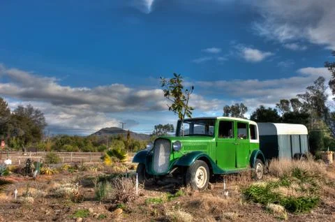Old car and trailer with Highway 33 in background. Stock Photos