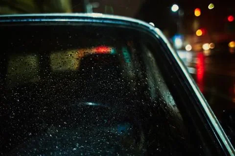Old car close-up, raindrops on the windshield, colored side, night, evening Stock Photos