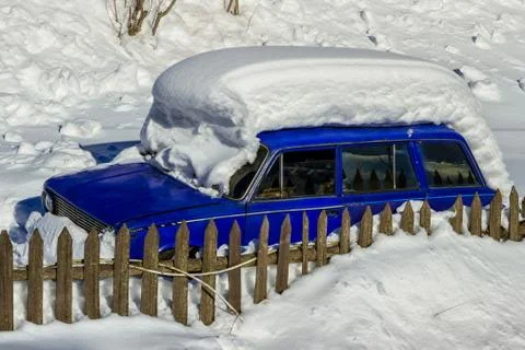Old car covered with a thick layer of snow Stock Photos