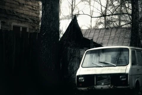 An old car crashed in a terrible Russian village White car in the forest 写真素材