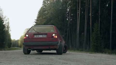 Old car drive through dirty forest roads Stock Footage 65311425
