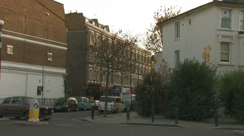 An old car drives down Shepherds bush Stock Footage 33981479