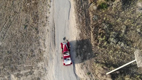 Old Car Driving Along Empty Country Road At Golden Summer Sunset Stock Footage 106579237