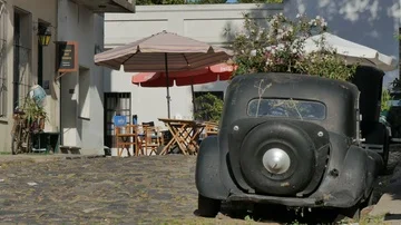 Old car with flowers in it in a small pedestrian street in the historic centr Stock Footage 85625349