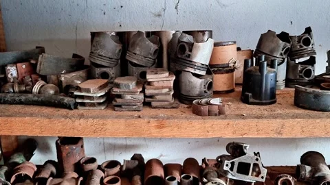 Old Car Pistons and Assorted Engine Spare Parts Stored on Workshop Shelves 動画素材 347597825