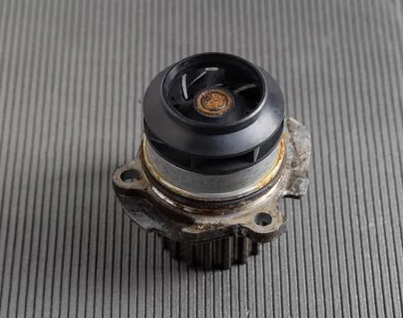 Old car pump on a gray background. The concept of repair and replacement of the Photos