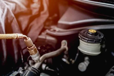 Old Car spark plug in a hand of Technician remove and change in engine room.. Stock Photos