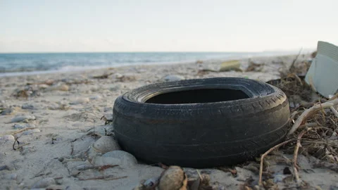 Old Car Tyre Waste On The Beach Stock Footage 293698739
