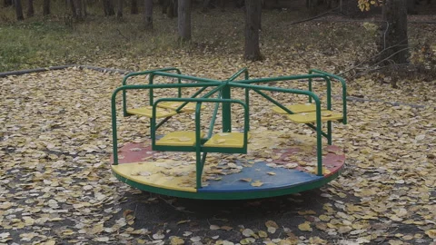 Old carousel is spinning against the background of the forest. Empty children's  Stock-Footage 97185881