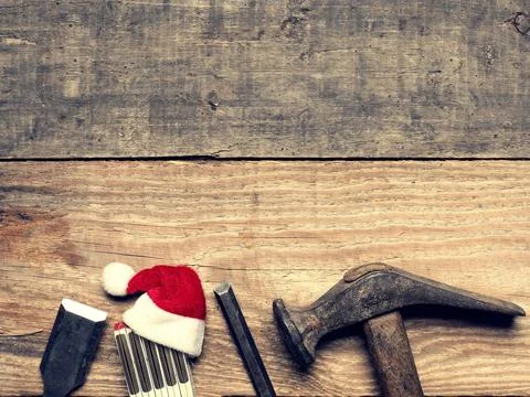 Old carpenter tools with the hat of Santa Stock Photos