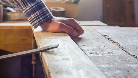 An old carpenter's workshop with an old tool. Rasp in the rugged hands of a Stock Footage 84553407
