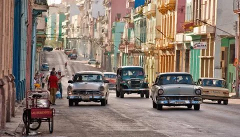 Old cars transiting in an avenue of Havana, Cuba Stock Photos