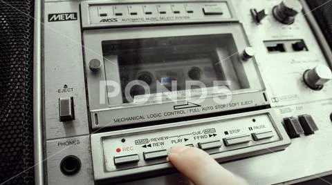 The old cassette player inserts a cassette into the boombox and presses ...