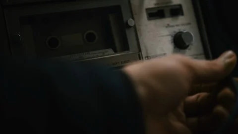 The old cassette player puts a cassette into the boombox. Video stock 125486670