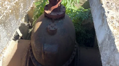Old Cast Iron Gate Valve on Irrigation Pipeline in Concrete Chamber Stock Footage 344029033