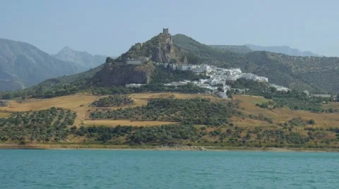 Old castle on a hill top with a small medieval town nearby a lake. 4k Stock Footage 66531134