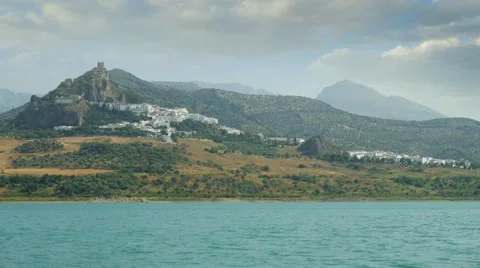 Old castle on a hill top with a small medieval town nearby a lake. Stock Footage 66531832