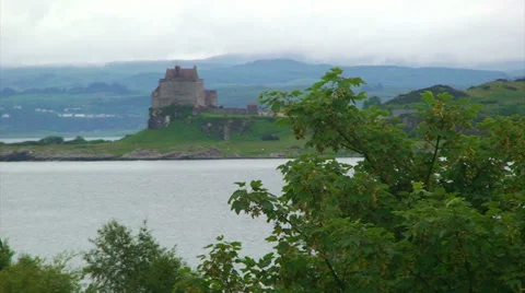 Old castle in the loch, behind tree branches Stock Footage 39815789